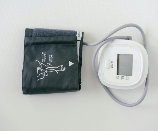 A digital sphygmomanometer on a white background, used for measuring blood pressure.
